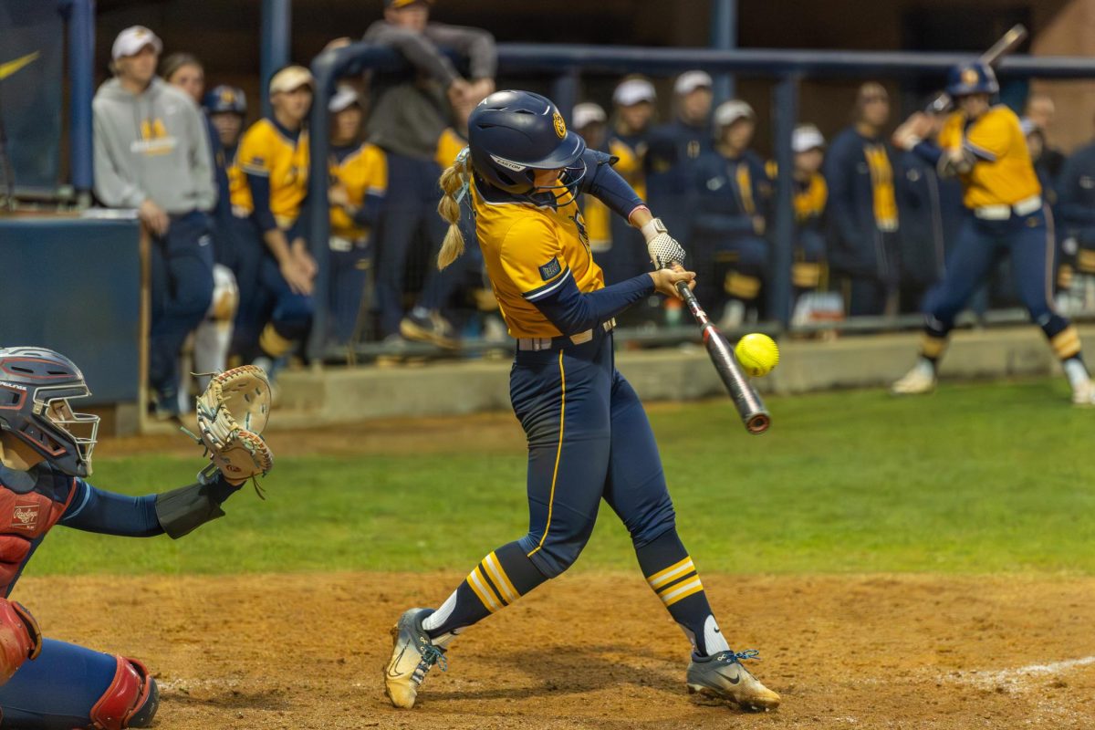 Sophomore infielder Adison Hicks hits during the first game. 