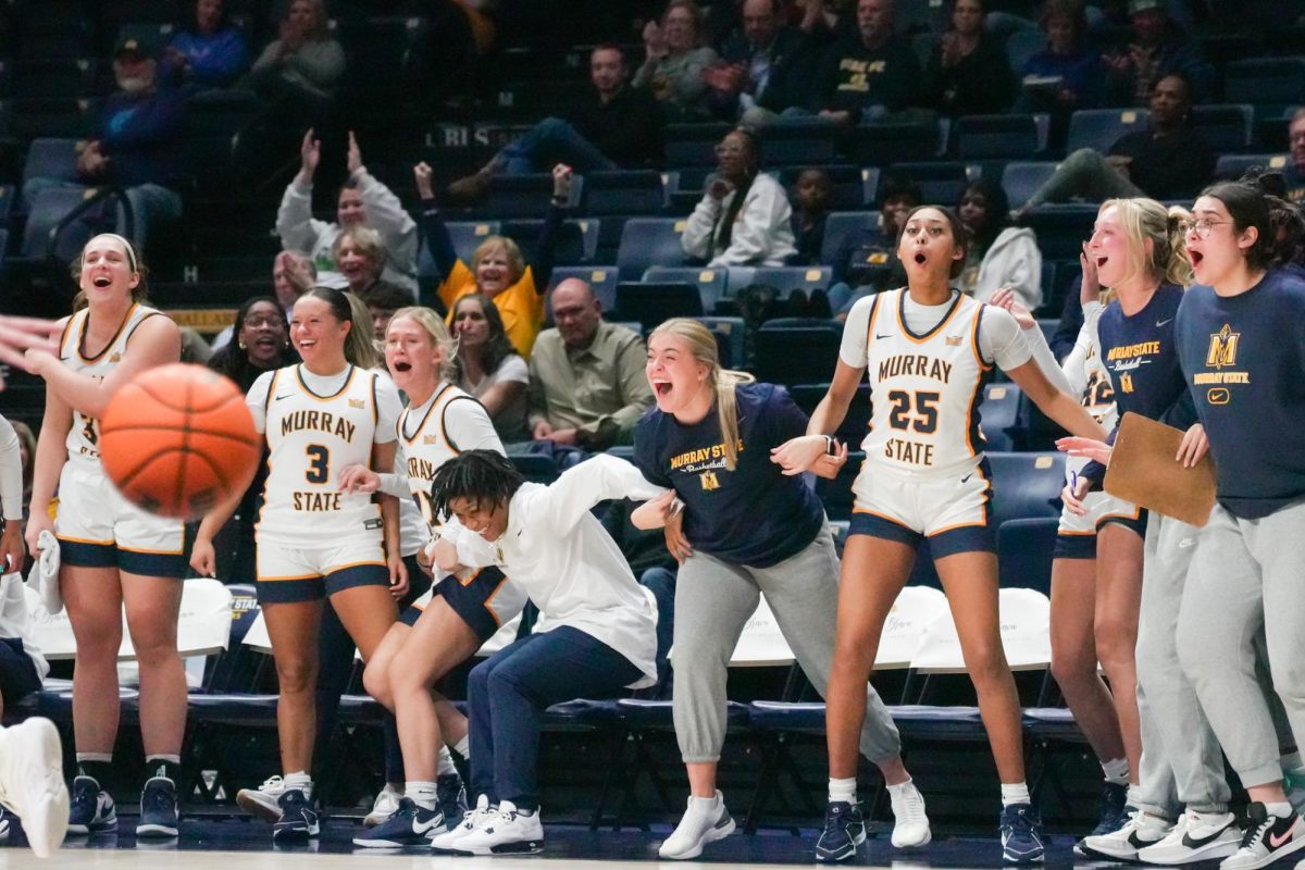 The Racers’ bench explodes in celebration after a play from freshman guard Zoe Stewart.