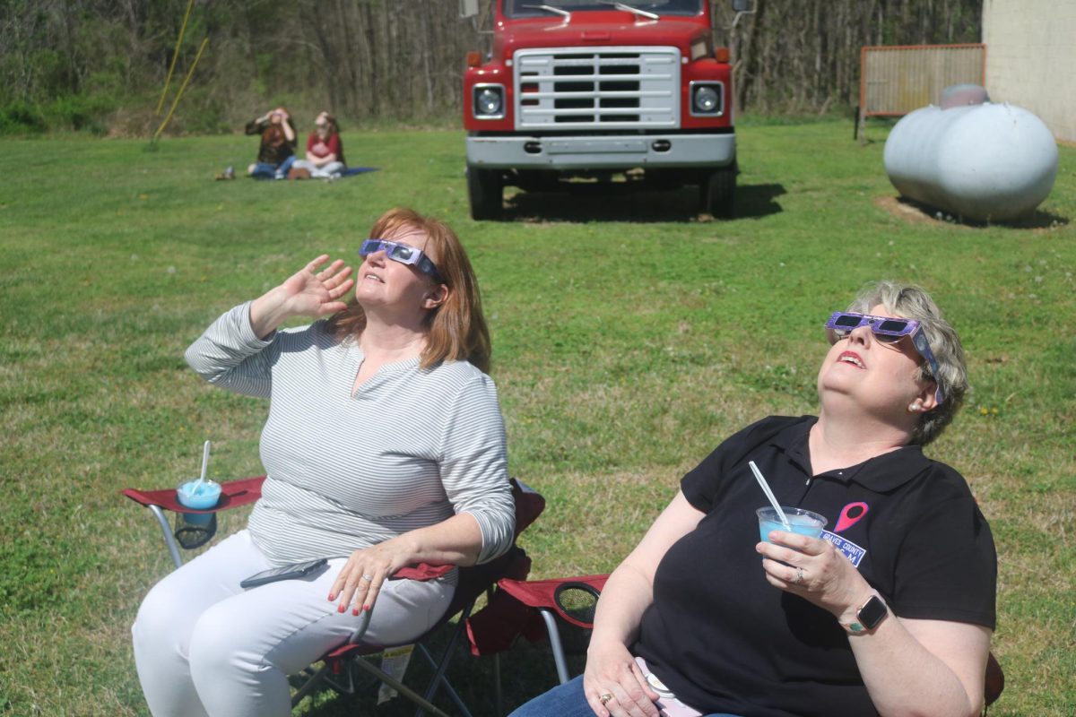 Georgeann Lookofsky and Jennifer Walker take in the sights of the eclipse on the lawn of the Melber Fire Station during the Graves County Eclipse Party on Monday, April 8. Several visitors to the small community had traveled hours to see about 30 seconds of totality. 