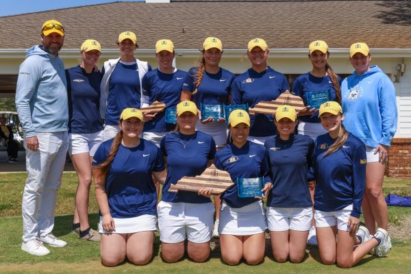 The entire womens golf team with head coach Philip Nelson after winning the tournament. 