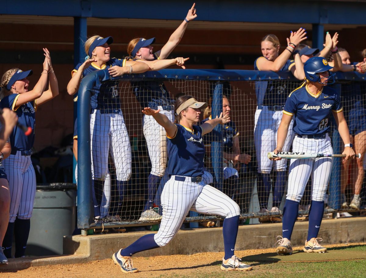 Senior Lily Fischer and the dugout celebrate a safe call from the umpire. 
