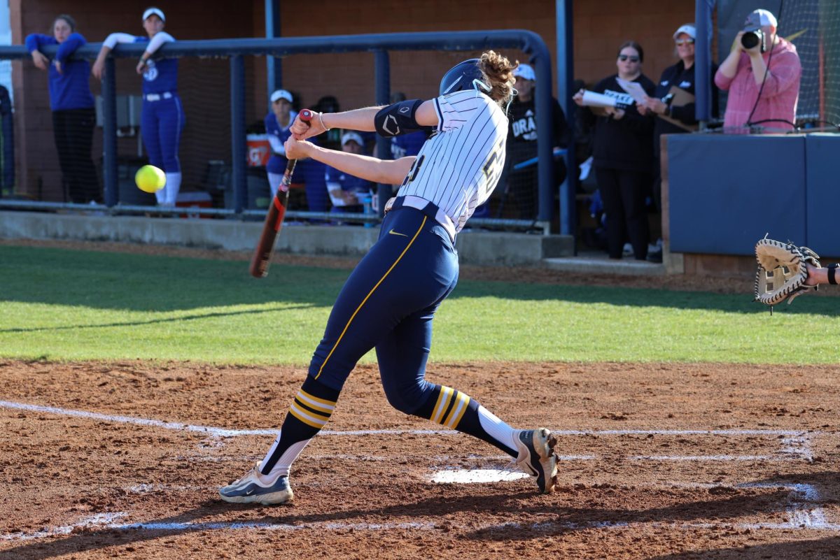 Junior outfielder Erin Lackey hits the ball.