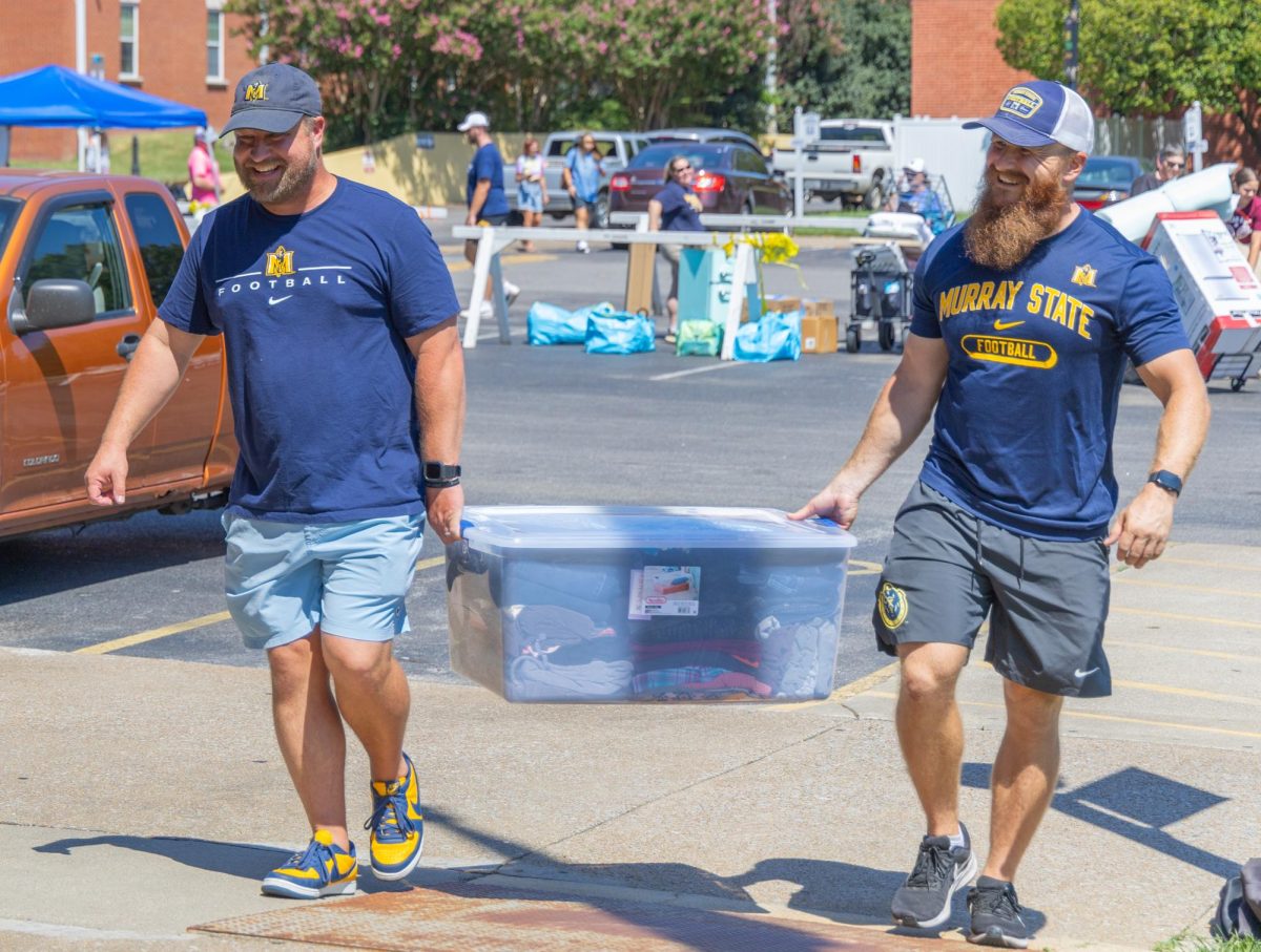 Head Football Coach Jody Wright and Head Strength Coach Cory Sullivan assist in move in. 