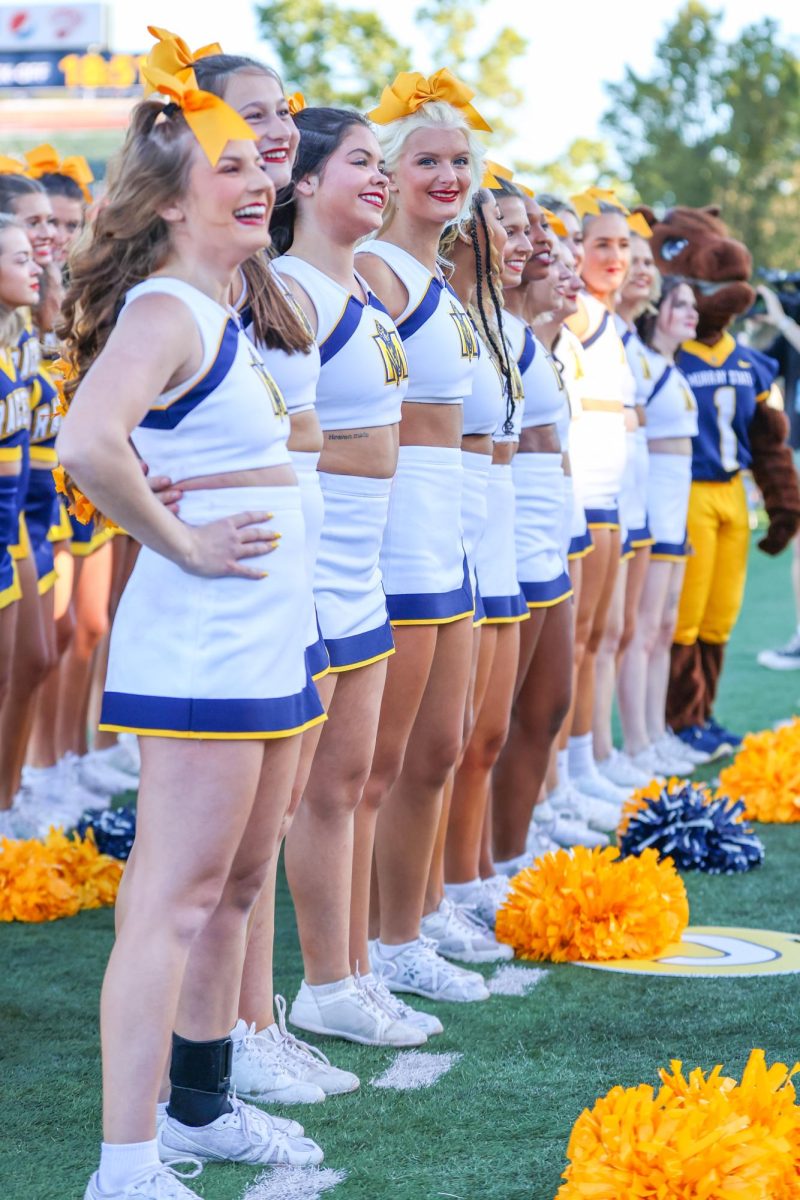 Racer cheerleaders smile during the bands pregame performance. 