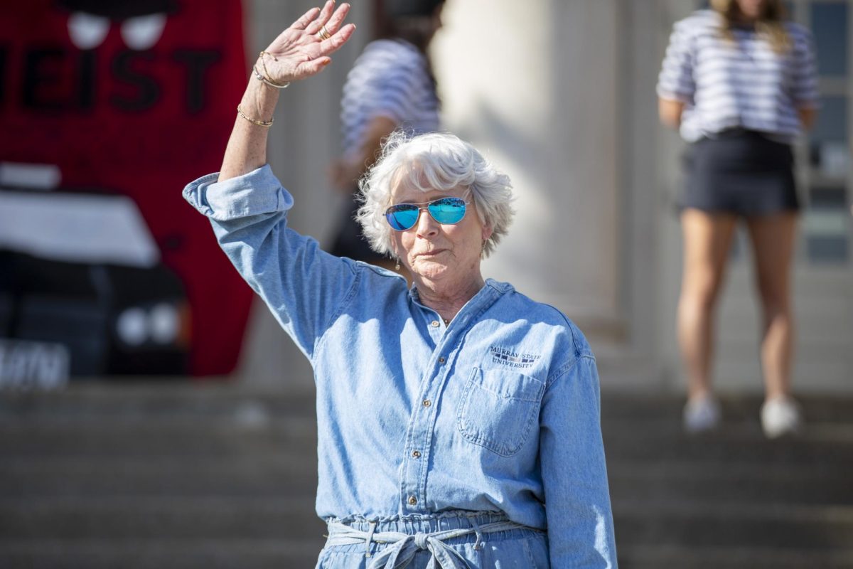 Jeanie Morgan waves to students as she celebrates All Campus Sing on the steps of Lovett Auditorium.