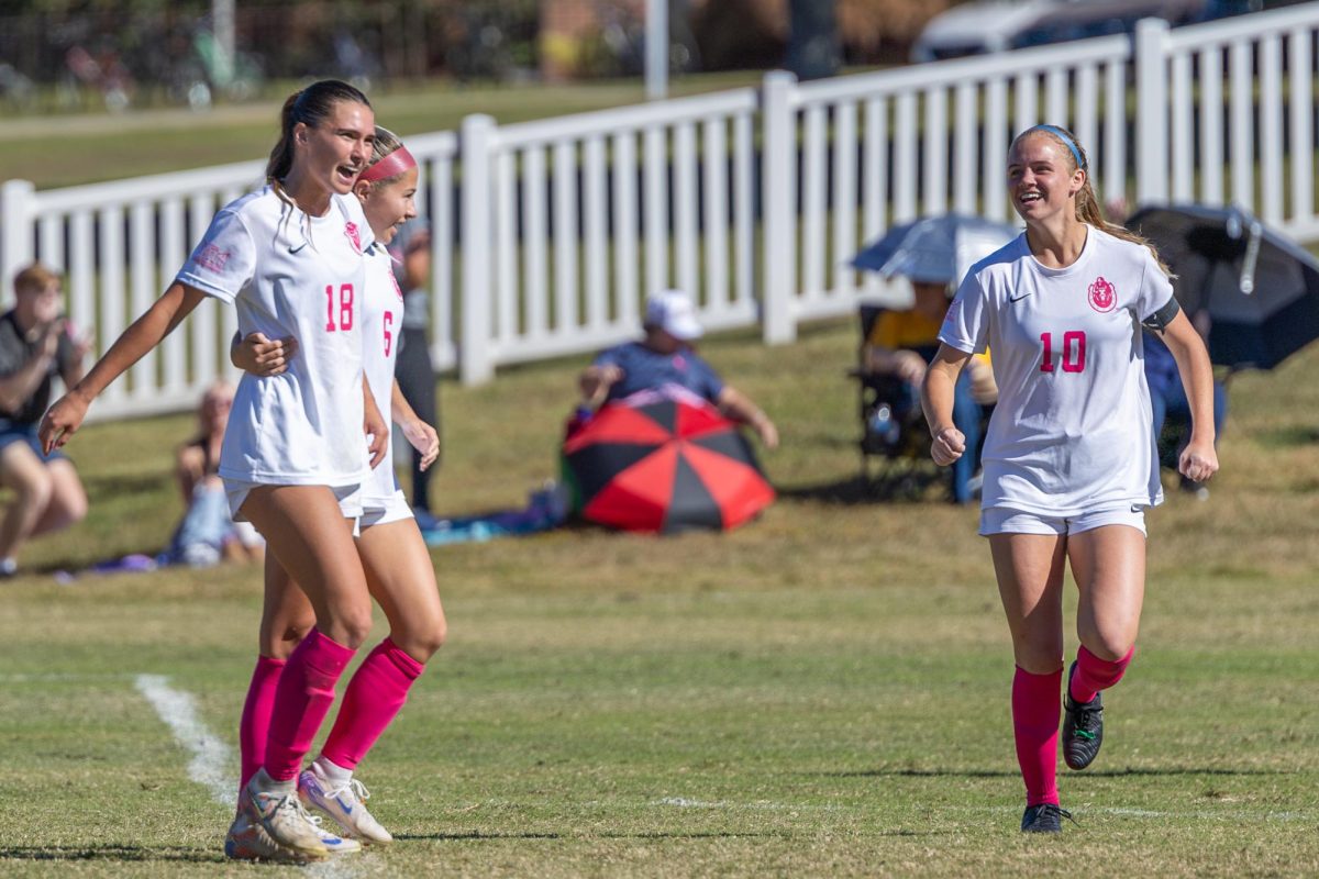 Junior forward Mary Hardy and freshman midfielder Natalie Miller celebrate with Sydney Etter after her goal. 