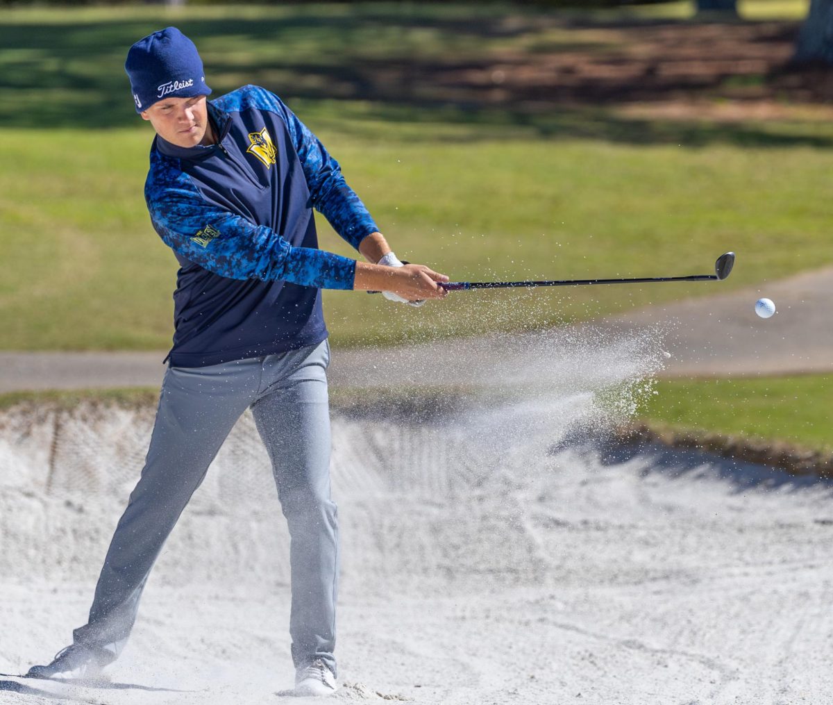 Senior Trey Lewis hits out of the bunker. 