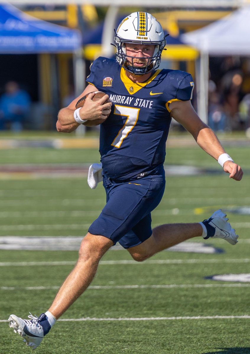 Graduate student quarterback Jayden Johannsen runs with the ball. 