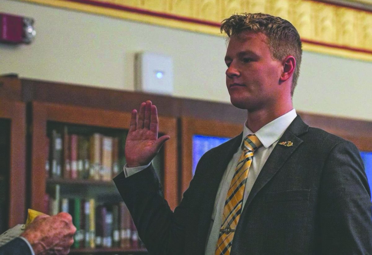 SGA president Brendan Hawkins is sworn in at Pogue Library.