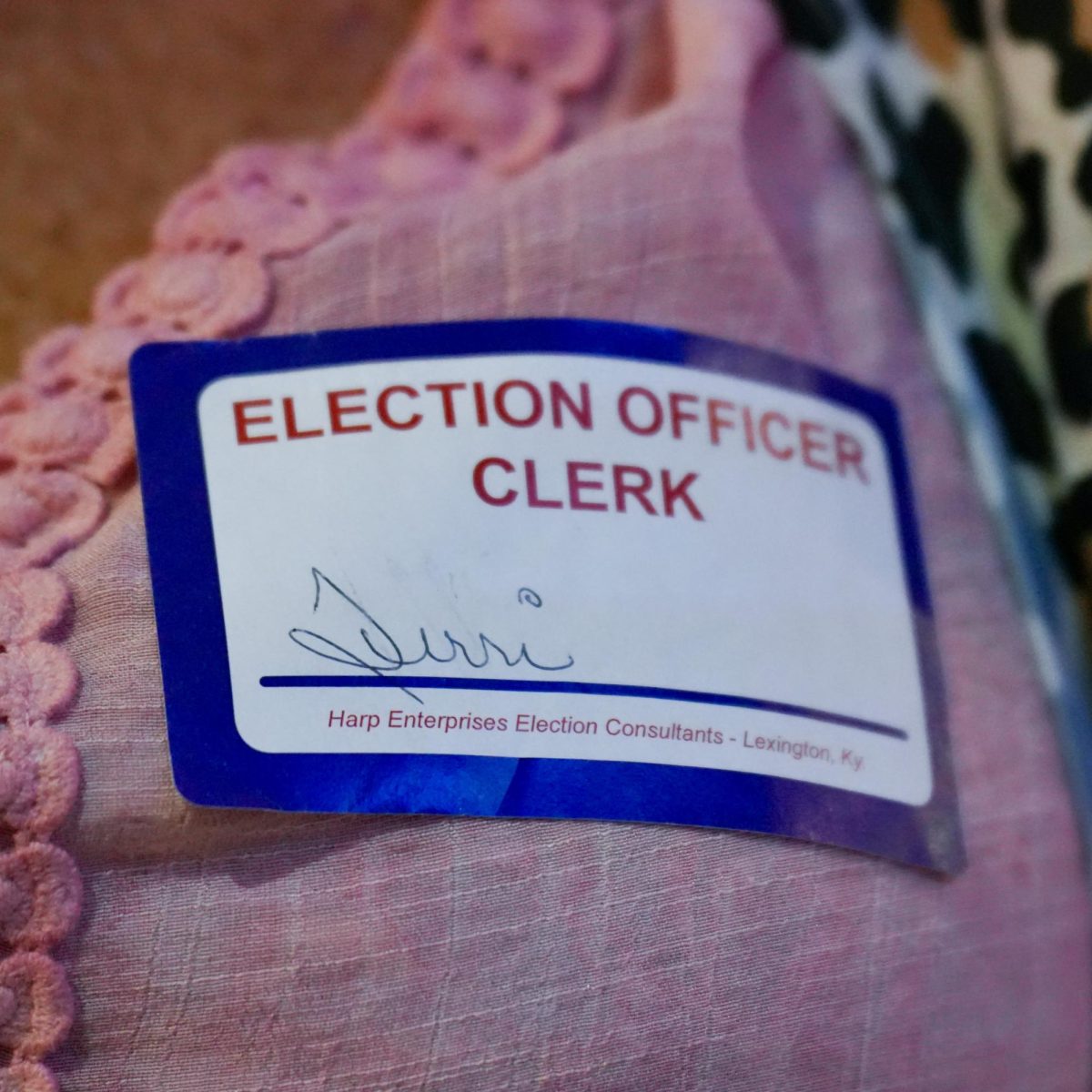 An election worker checks voters in and gives them their ballot. 