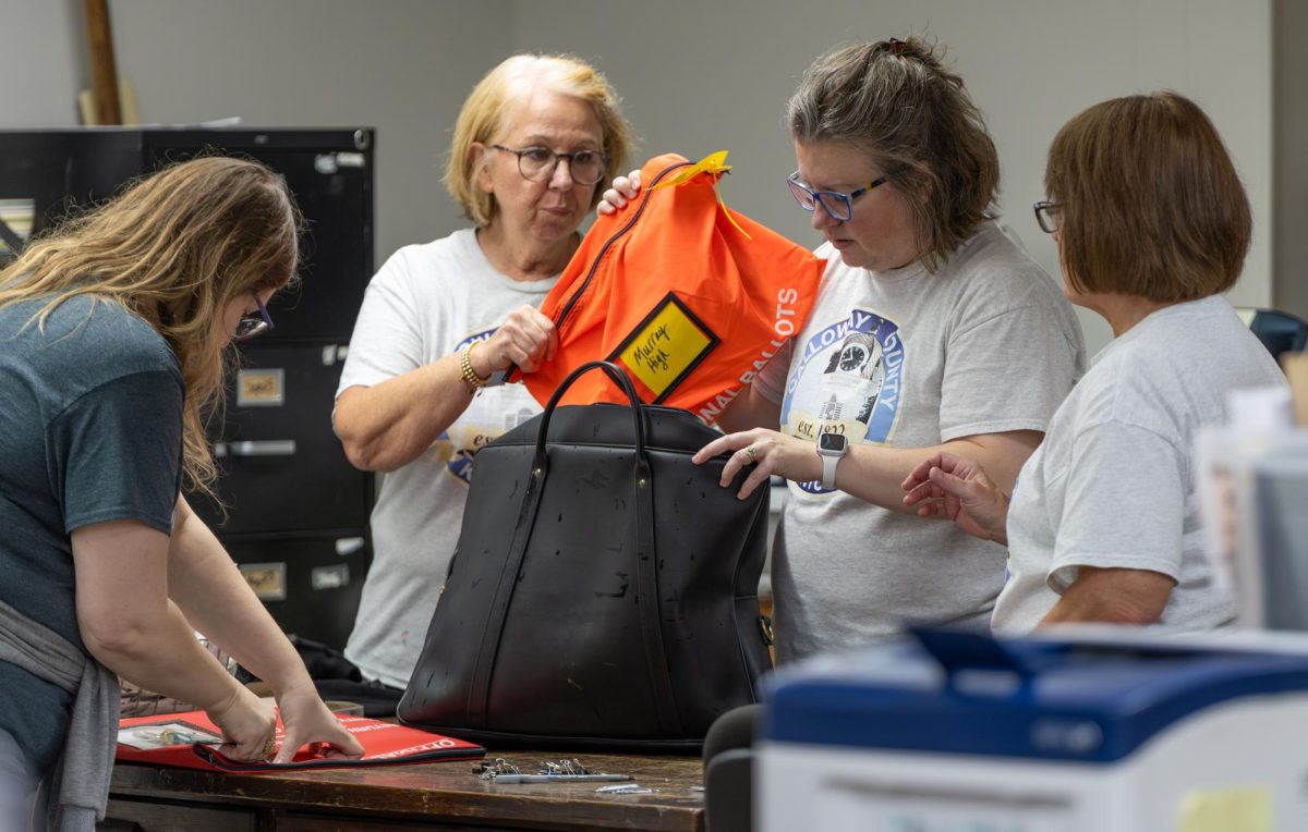 Election officials count ballots as precinct workers bring them to the courthouse. 