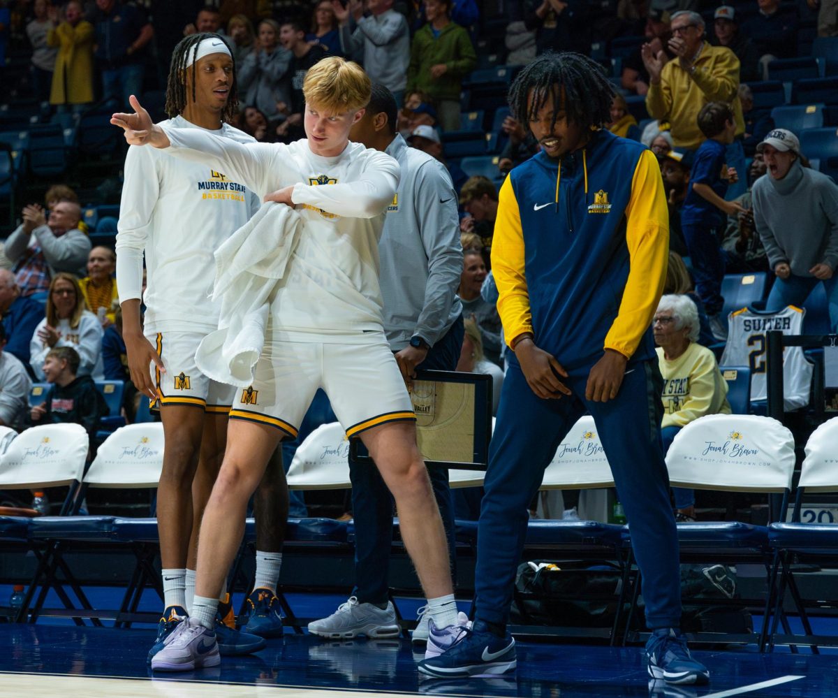 The Murray State bench celebrates after Ellington's dunk.