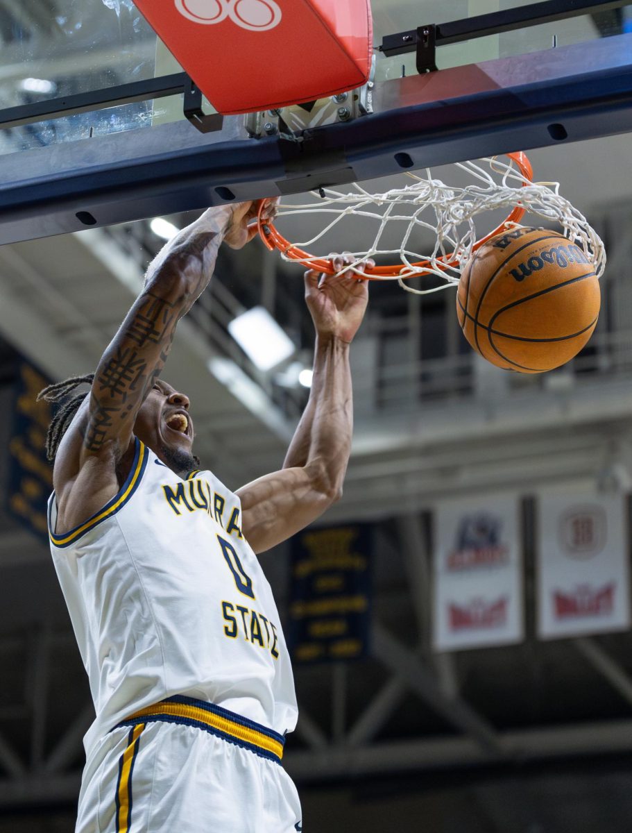 Senior guard Kylen Milton throws down a dunk in transition.