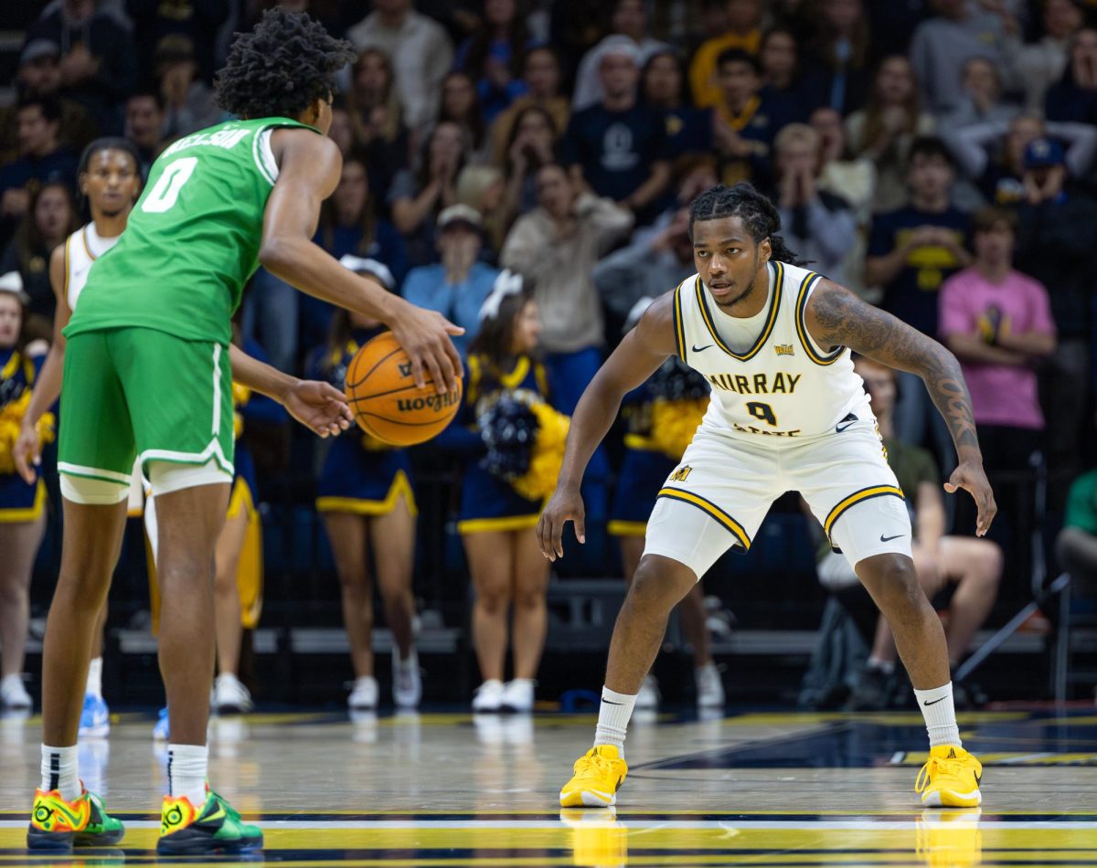 Senior guard Terence Harcum defends a Utah Valley player. 