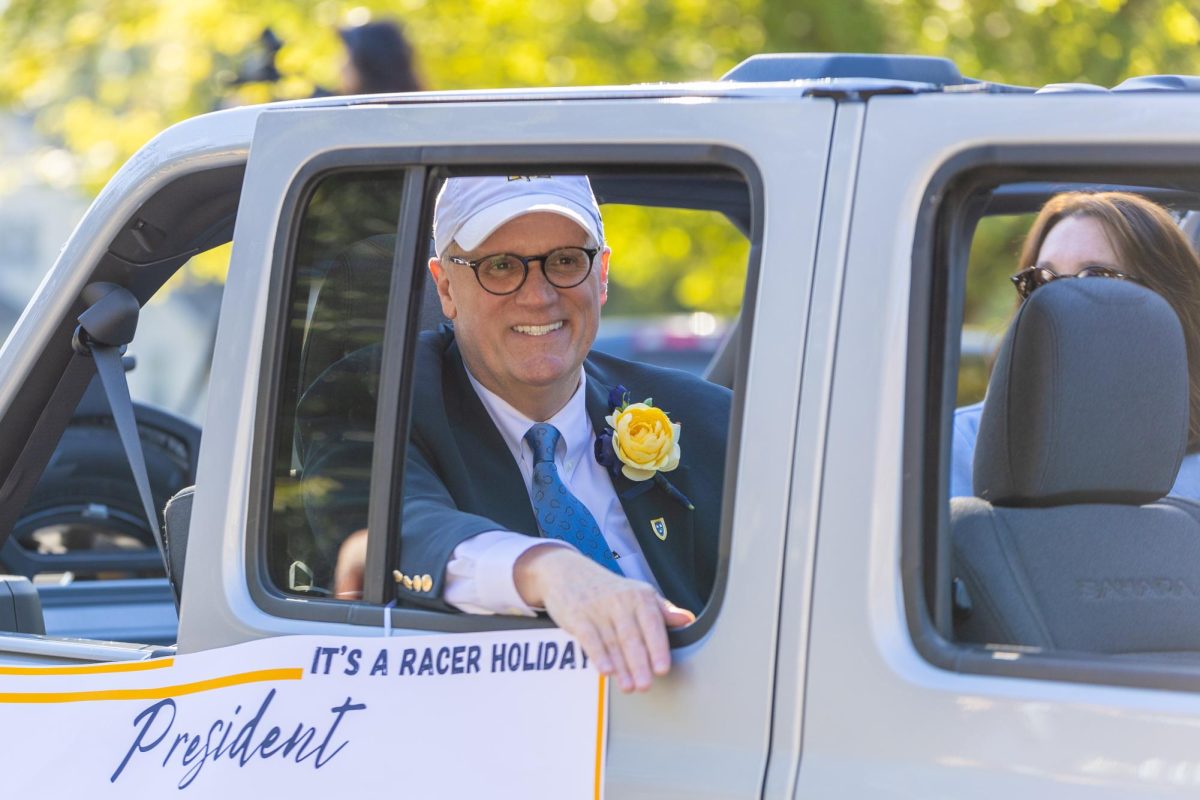 Bob Jackson rides in the Homecoming parade for the last time as the University president. 