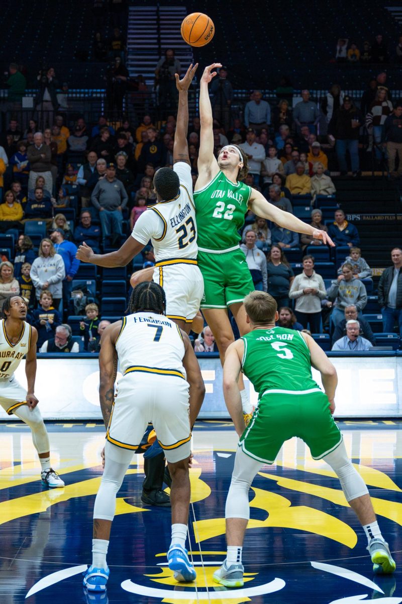 Senior forward Nick Ellington fights for the opening tip/. 