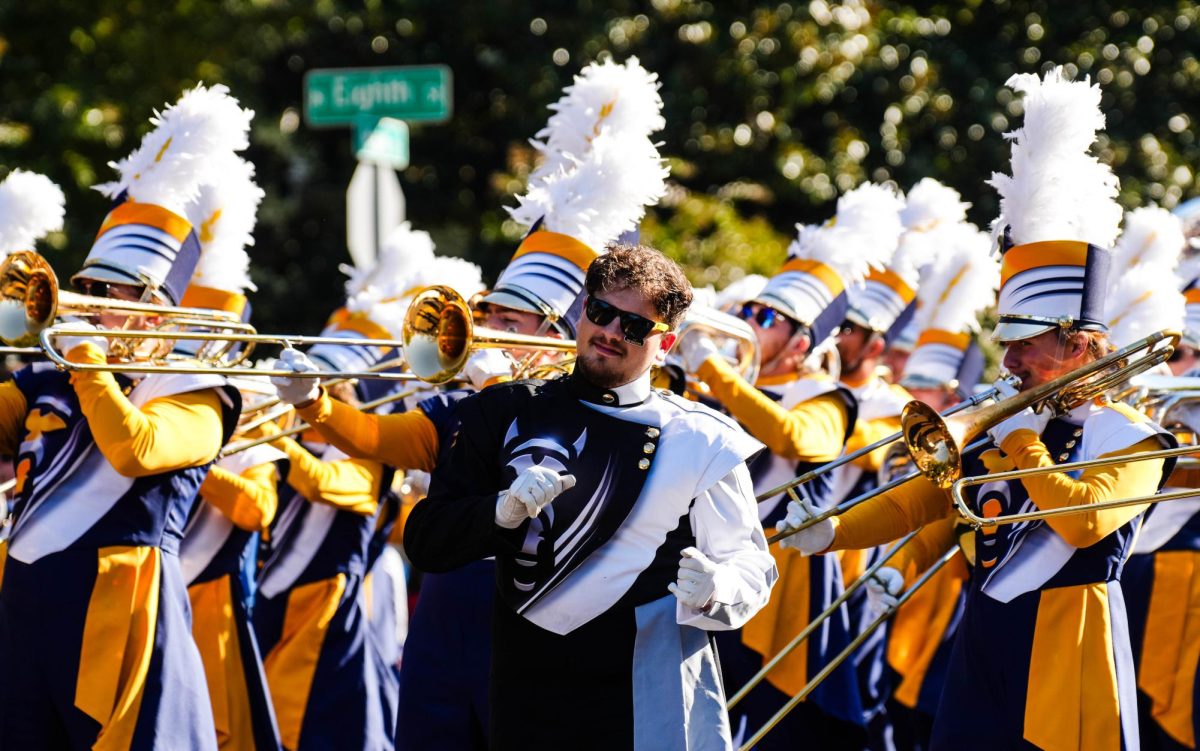 Racer Band students march during Homecoming, showcasing a glimpse into the busy schedules of students in the music department. 