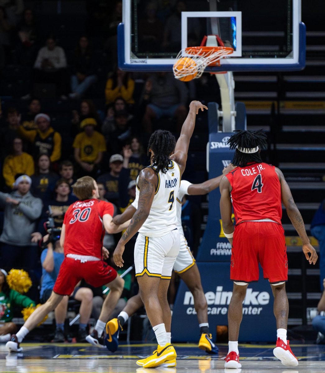 Senior guard Terence Harcum watches a 3-pointer go through the hoop.