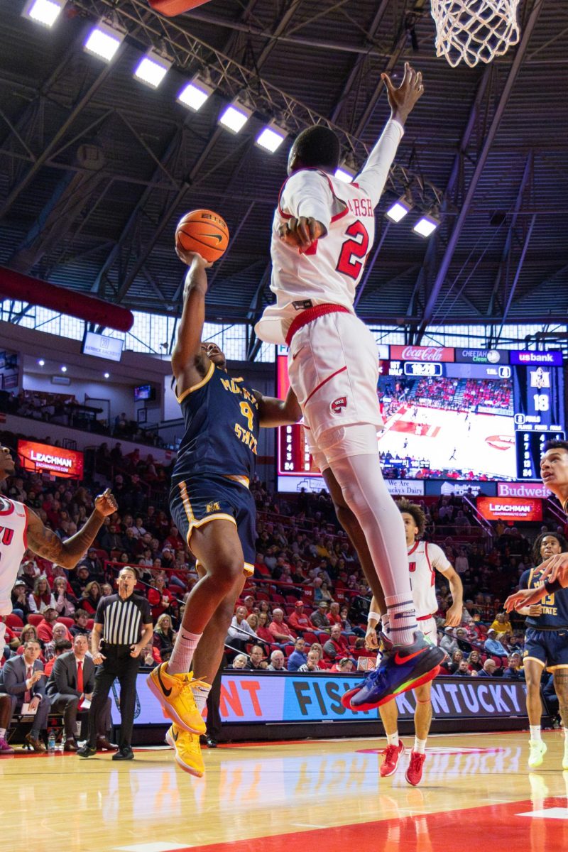 Senior guard Terence Harcum shoots a floater over a Western Kentucky defender.