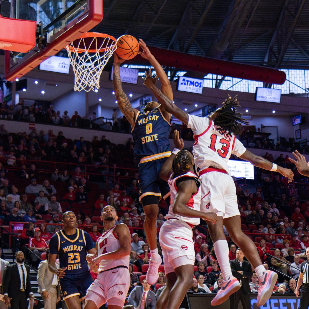 Senior guard Kylen Milton dunks over WKU's defense.