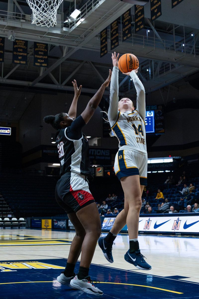 Racers' guard/ forward Ava Learn, shooting a shot over opponent