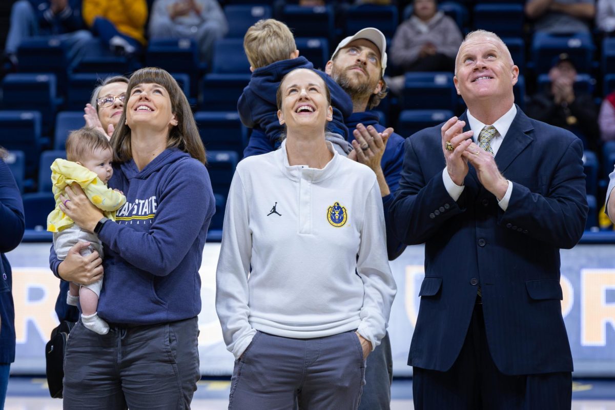 Amber Guffey watches her jersey get retired.