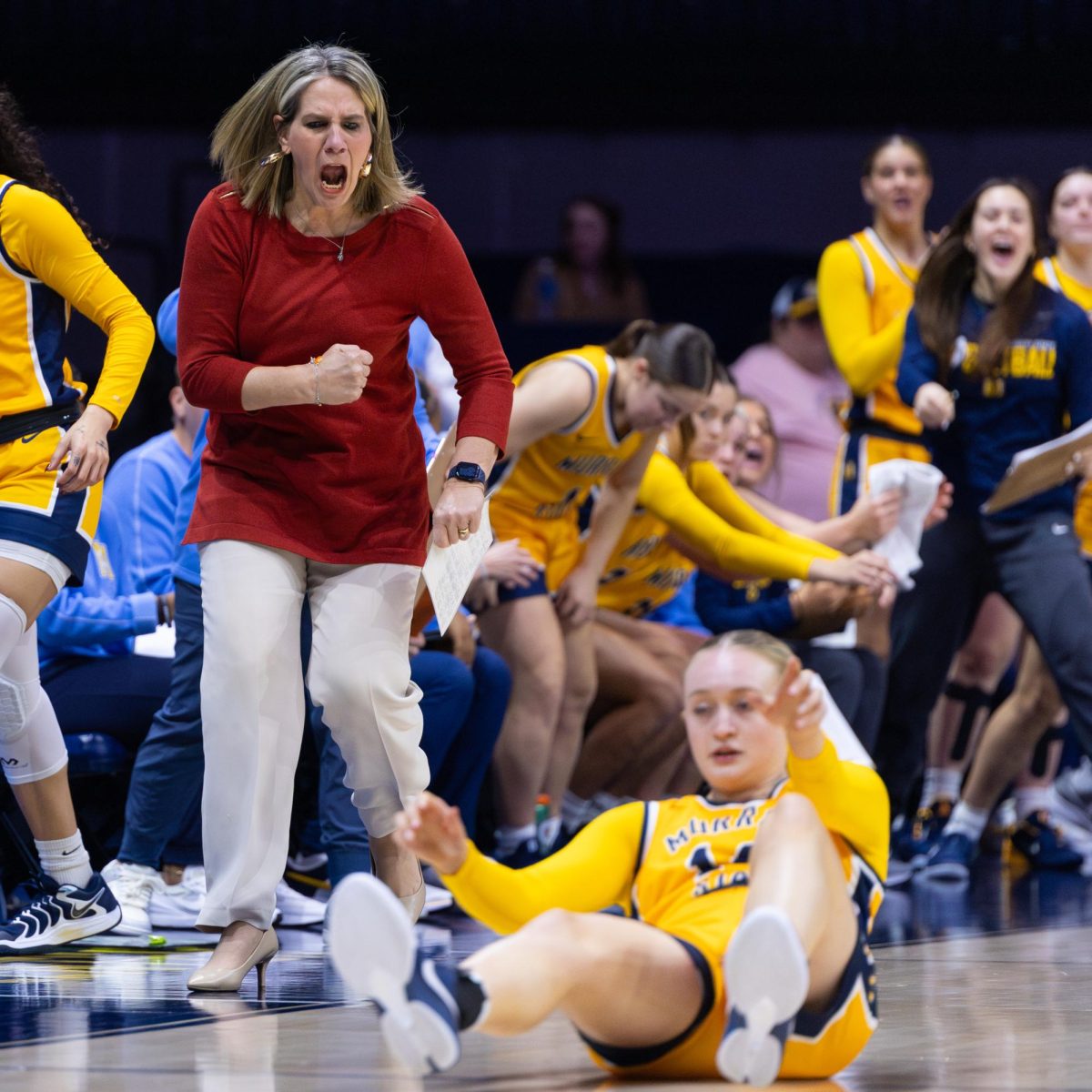 Head Coach Rechelle Turner excited after senior forward Ava Learn draws a charge.