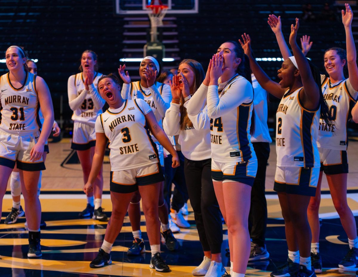 The Racers cheer for coach Rechelle Turner after tying the win record. 