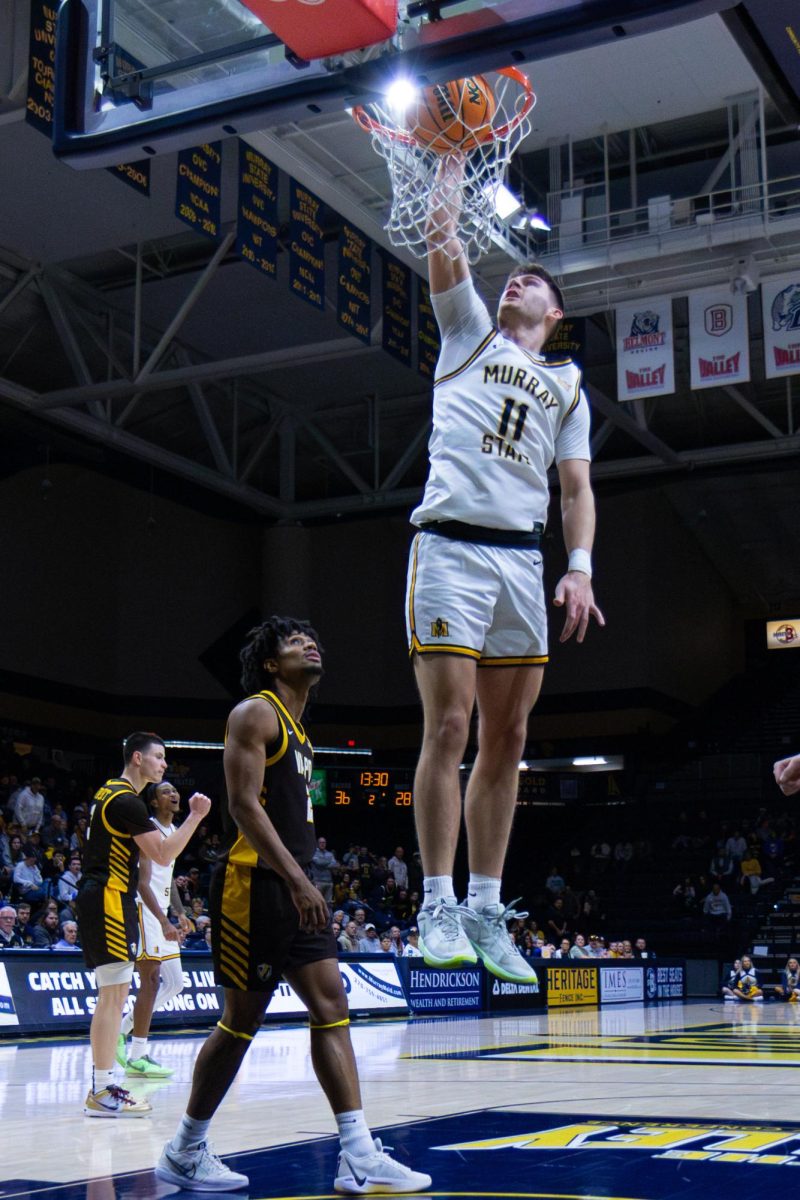 Junior guard Justin Morgan throws down a one handed dunk. 