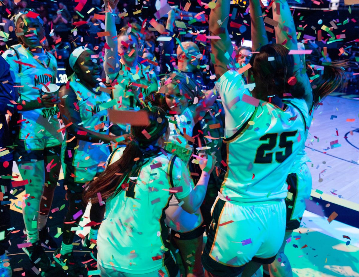 The Racers celebrate with Head Coach Rechelle Turner after she became Murray State women's basketball all-time wins leader with 141 career wins. 