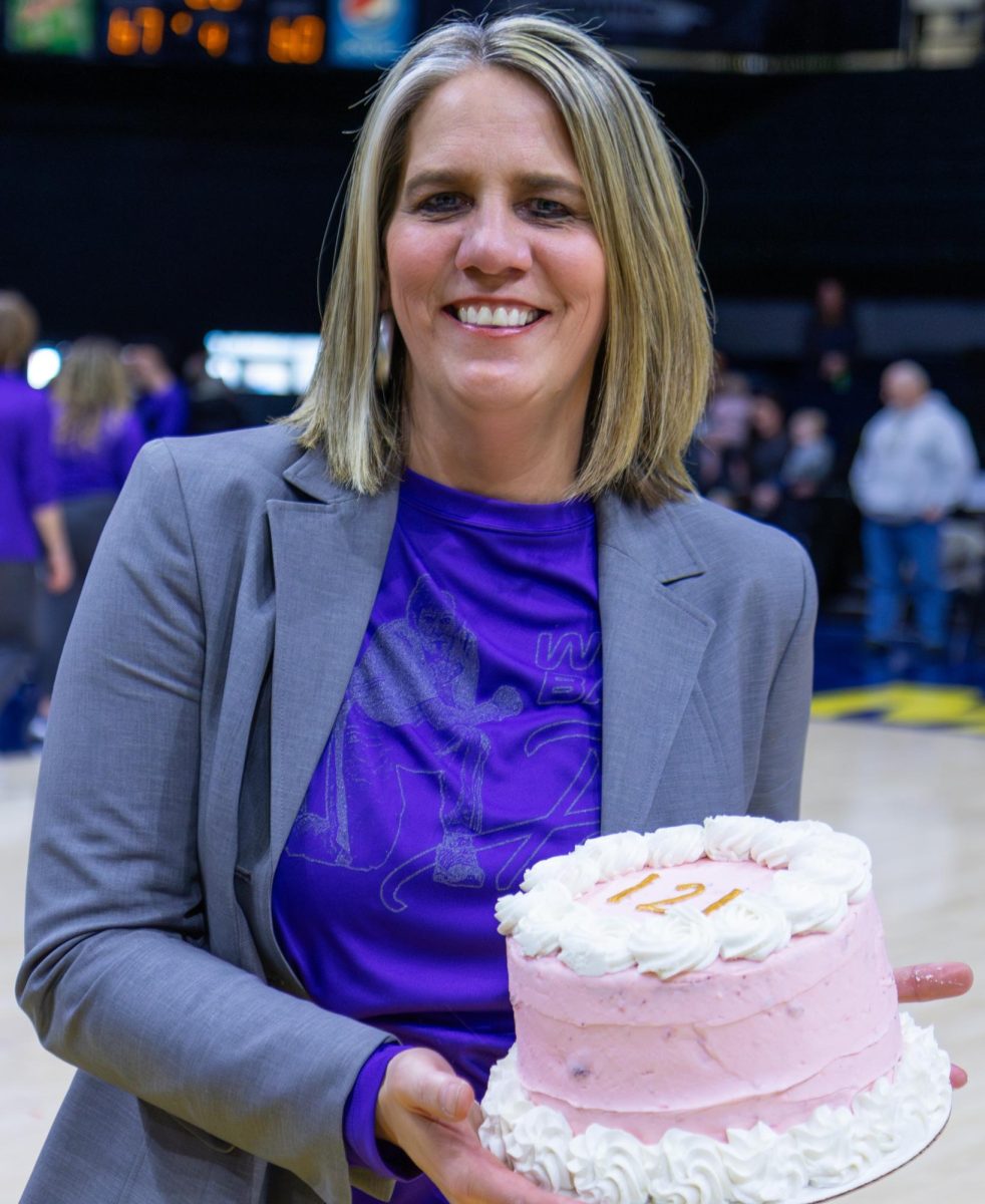 Head Coach with her cake celebrating 141 career wins. 