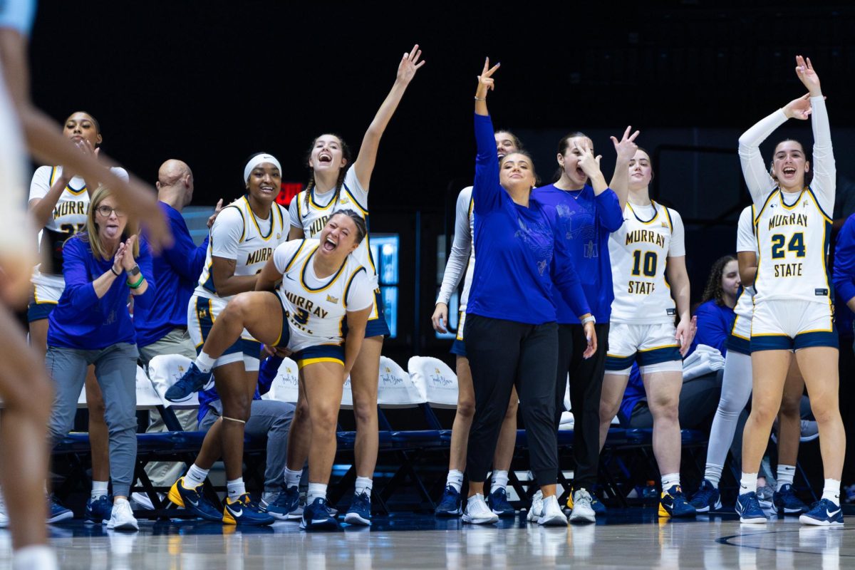 The bench celebrates after a three point shot. 