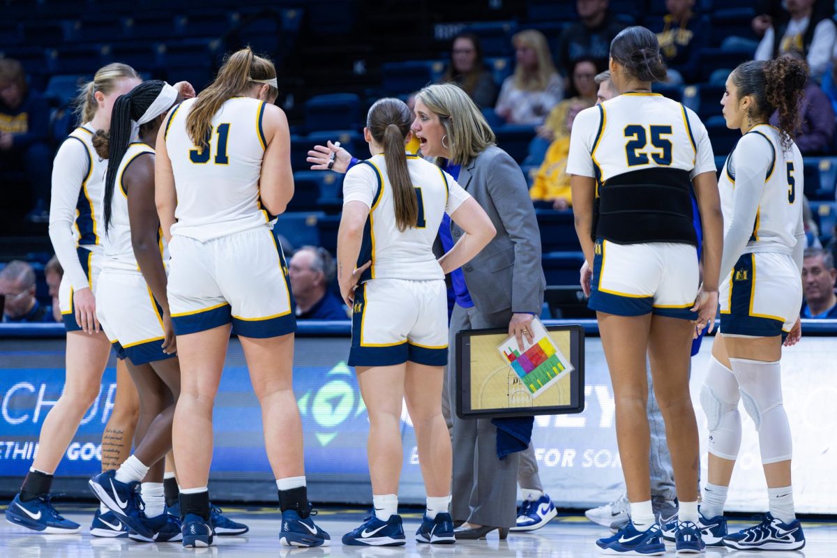 Head Coach Rechelle Turner explains the game plan with some members of her team.