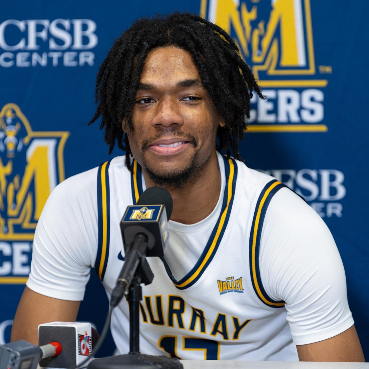 Junior forward Alden Applewhite listening to a question at the postgame press conference.