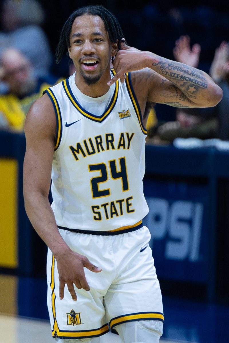 Senior guard JaCobi Wood celebrates after making a three pointer. 