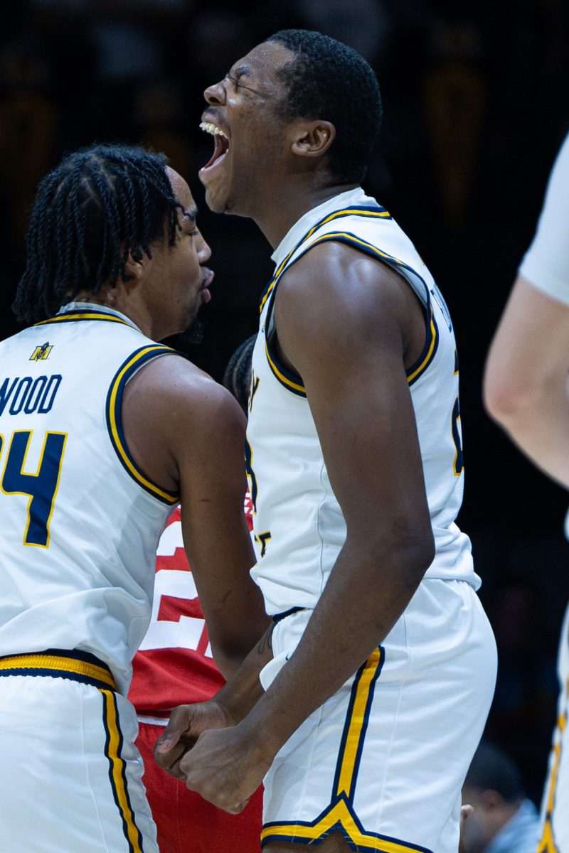 Senior forward Nick Ellington celebrates after making a shot and drawing a foul.