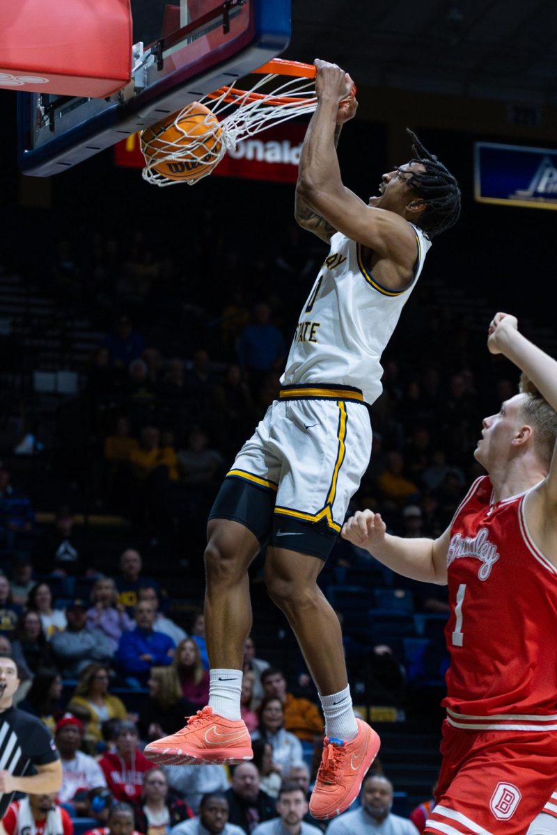 Senior guard Kylen Milton slams down a two handed dunk. 