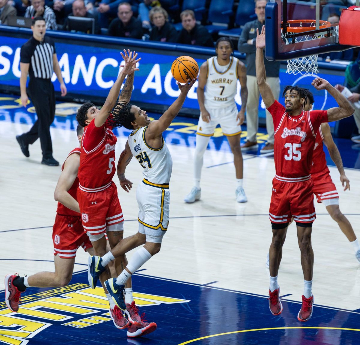 Senior guard JaCobi Wood goes for a layup. 