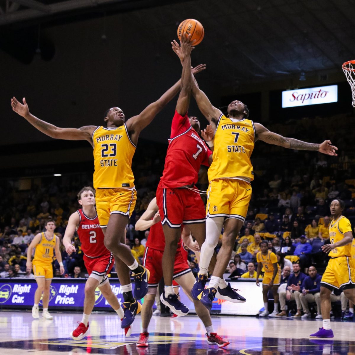 Senior forward Nick Ellington and senior guard AJ Ferguson fight for a rebound with a Belmont player. 