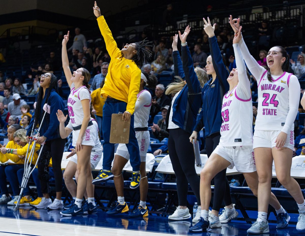 The bench celebrates after a three point shot. 