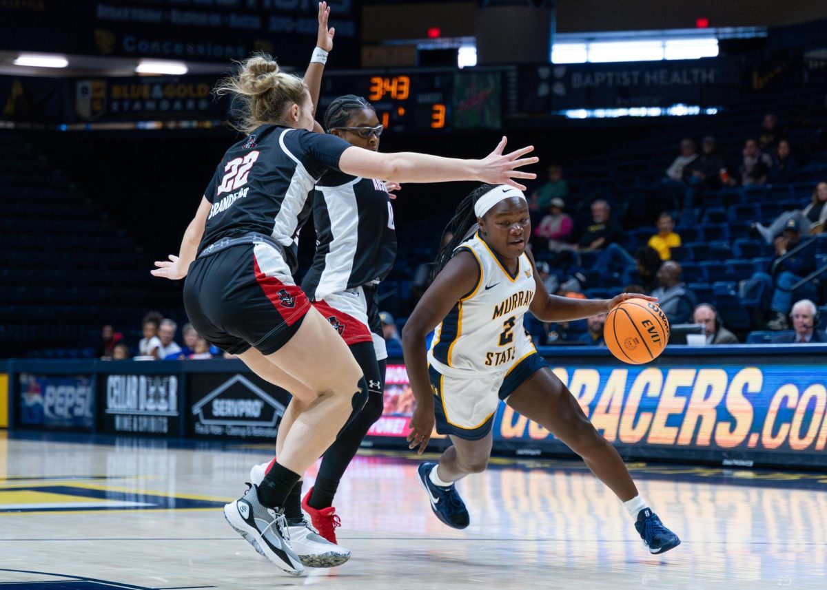 Sophomore guard Haven Ford drives past two Austin Peay defenders.