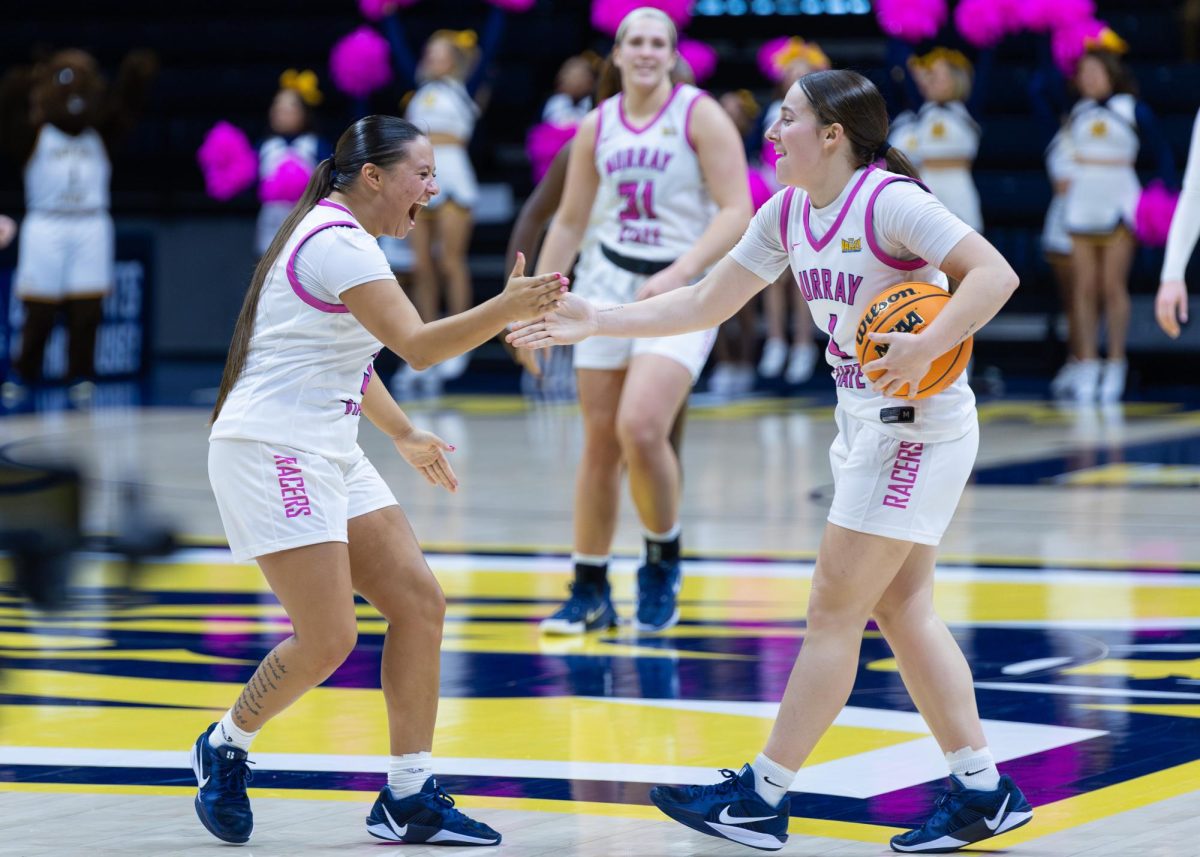 Junior guard Briley Pena and sophomore guard Halli Poock celebrate the win as the final buzzer sounds. 