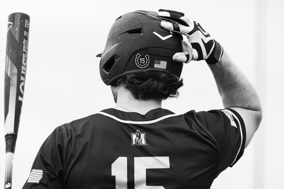 Redshirt senior outfielder Jonathan Hogart stands in the on deck circle preparing to hit.