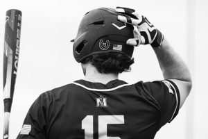 Redshirt senior outfielder Jonathan Hogart stands in the on deck circle preparing to hit. 