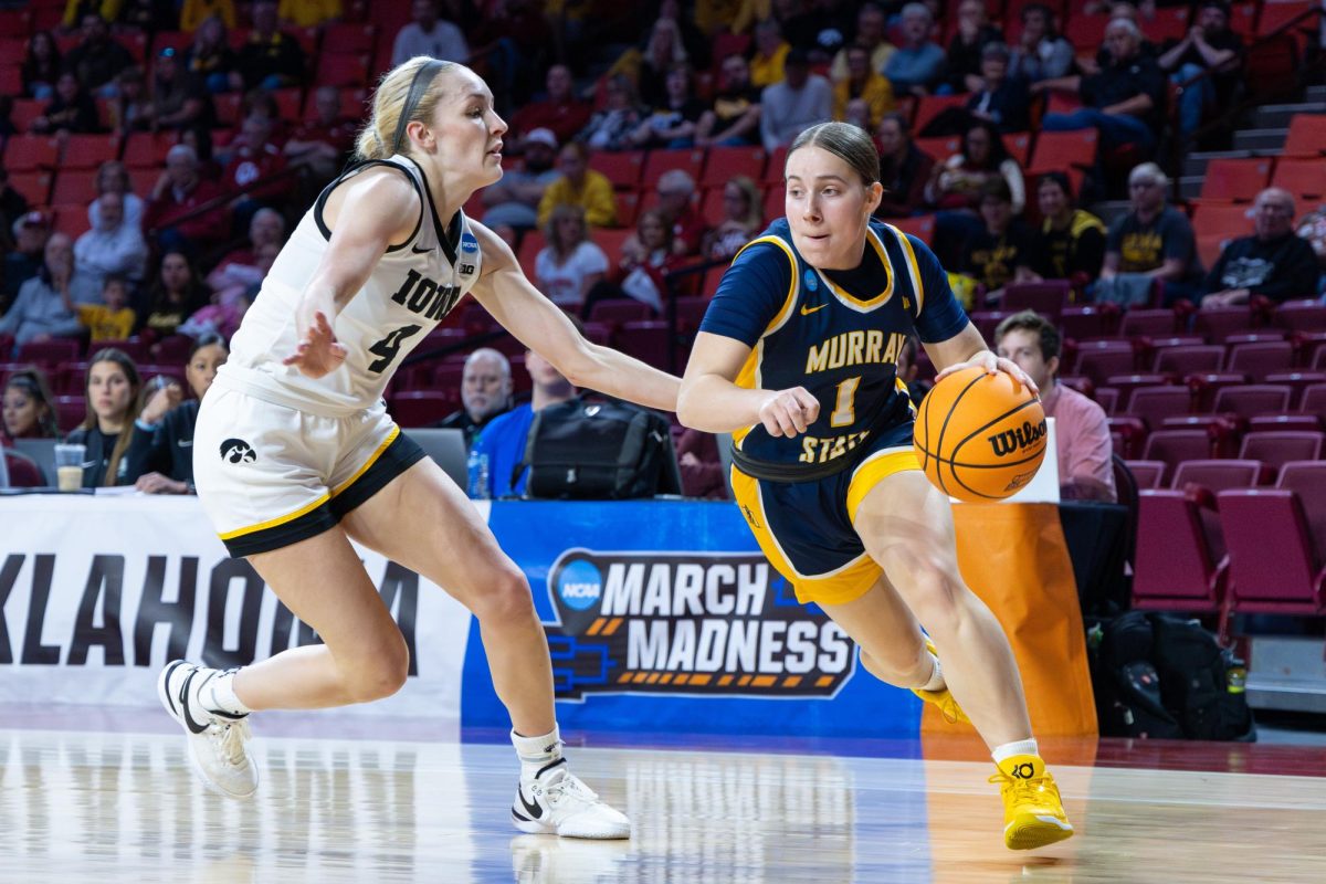 Sophomore guard Halli Poock drives past an Iowa defender.