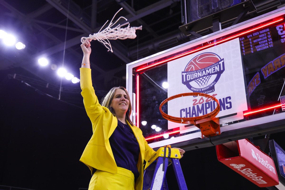 Head Coach Rechelle Turner celebrates after cutting down the net.