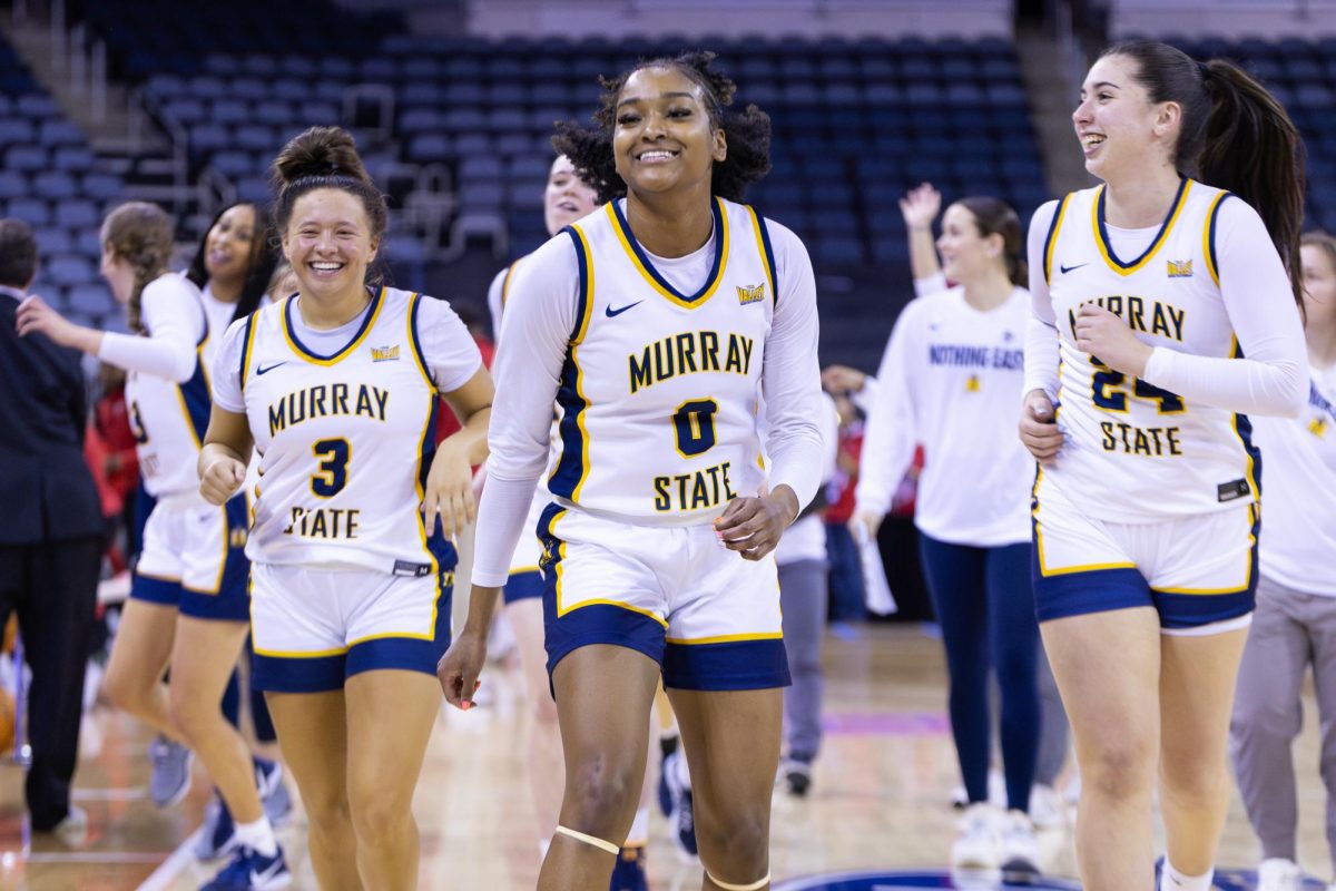 From left to right: Briley Pena, Jada Cook, and Adriana Blazquez smile while walking off the court after winning the game. 