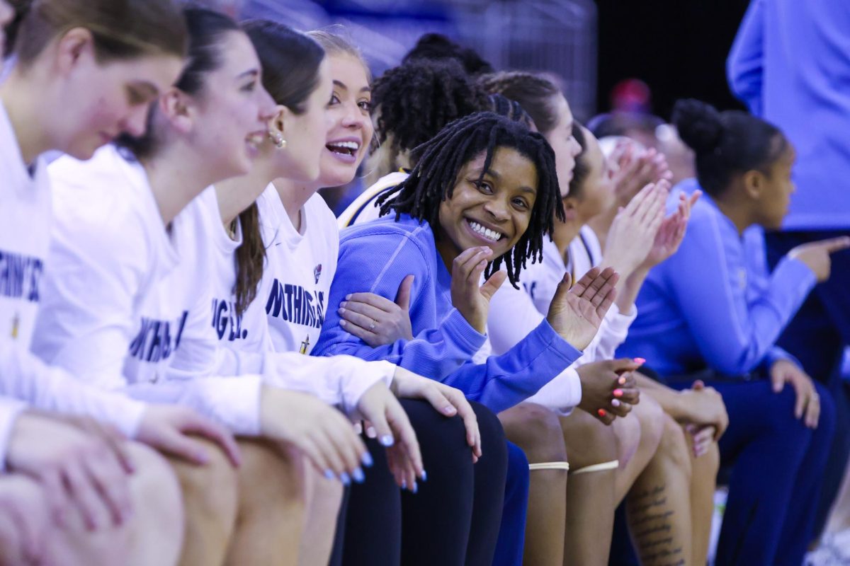 Graduate assistant coach coach Kayla Mitchell gives the shoes up to the camera.