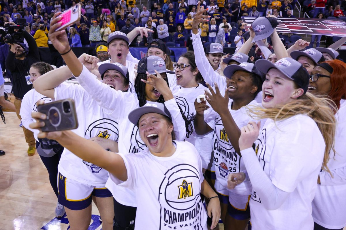 The team take a selfie while celebrating. 