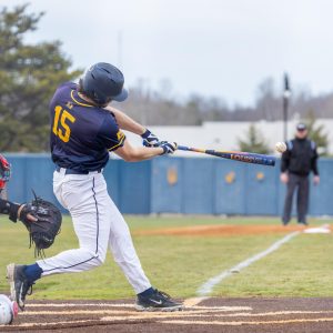 Senior outfielder Jonathan Hogart hits a ball to the outfield.